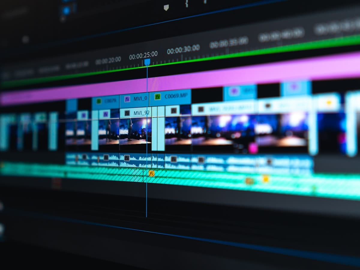 Video editor working at a dual-monitor desk